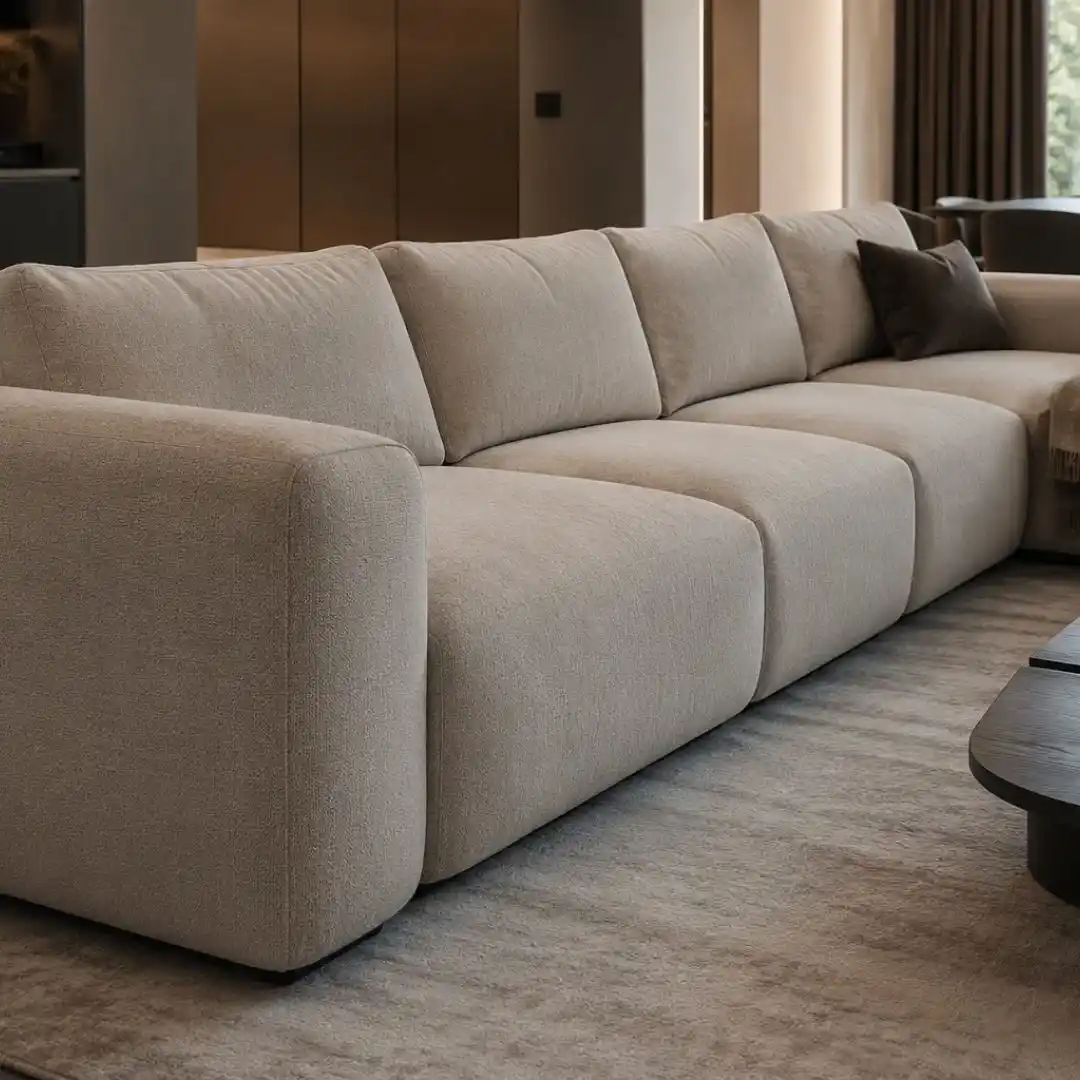 Modern upholstered sectional sofa in a minimalist living room showcasing durable furniture repair solutions, premium fabric upholstery, and contemporary interior styling.