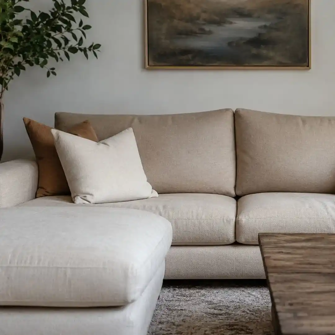Modern beige sectional sofa in a stylish living room showcasing how Dubai sofa upholstery can revive your living room with elegance and comfort.