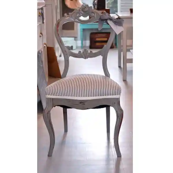 Classic wooden dining chair with striped fabric upholstery in Dubai